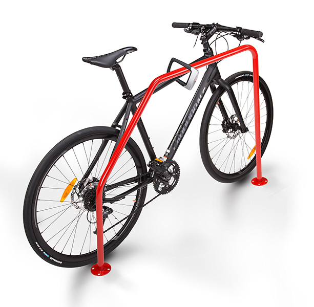 A bike locked to a rack of color red