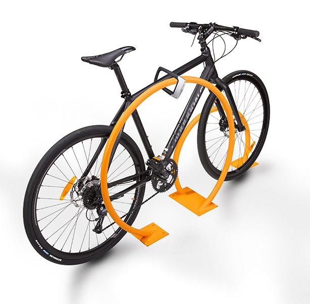 A bike locked to a rack of irregular orange shape.