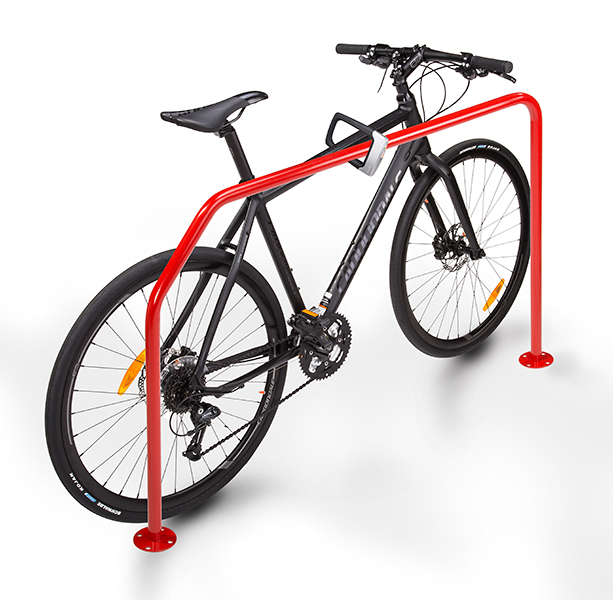 A bike locked to a rack of red irregular shape.